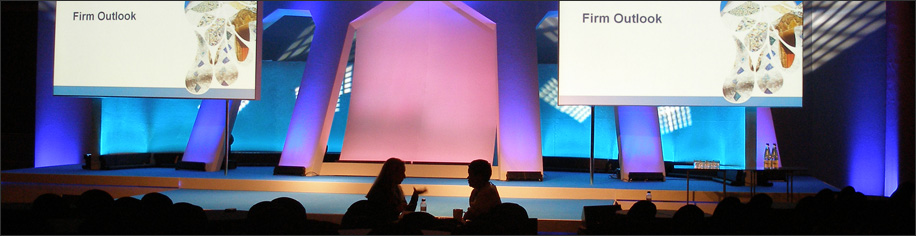 Conference audio visual installation with twin projector screens and custom−built stage